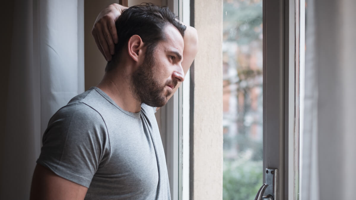 Man looking out of window