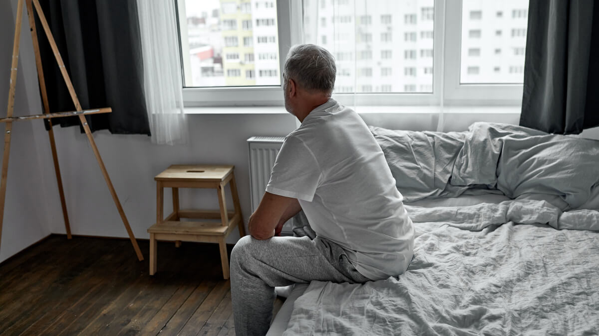 Grieving man on bed