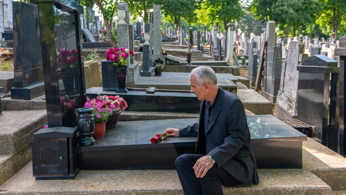 Man sat at grave