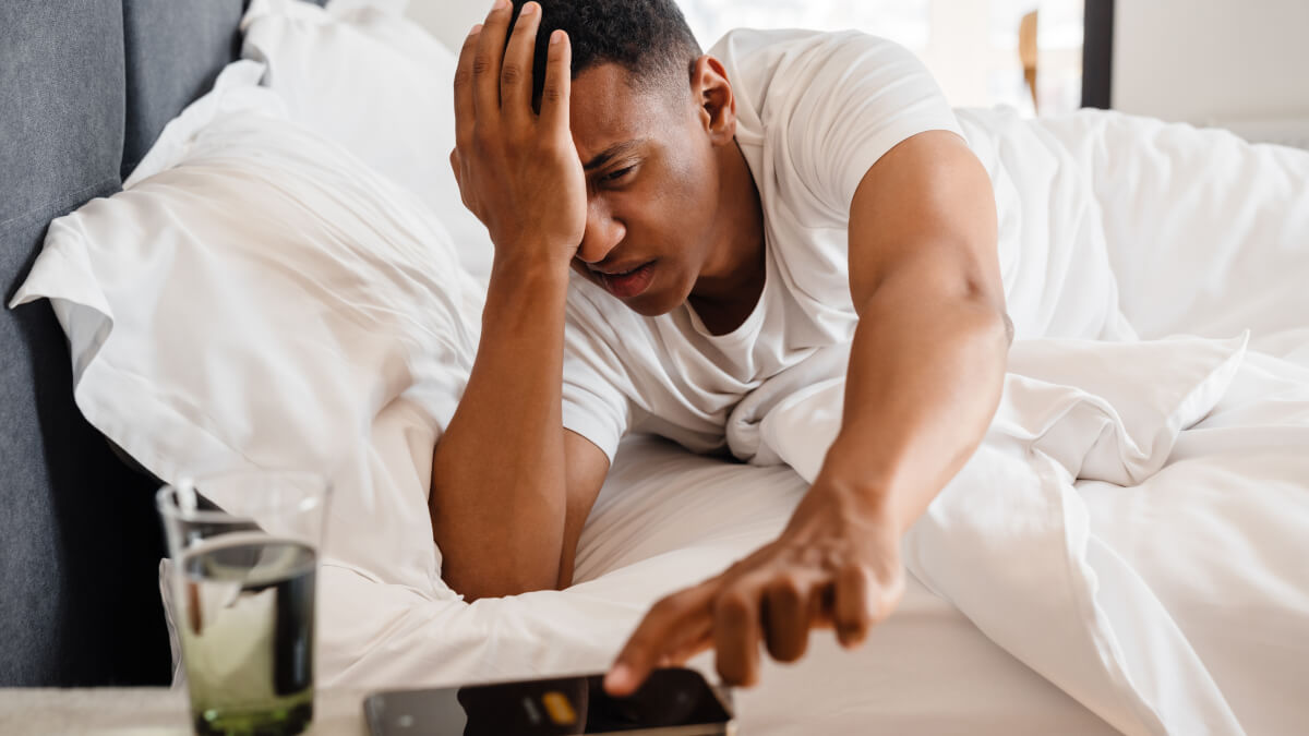Man stressed in bed
