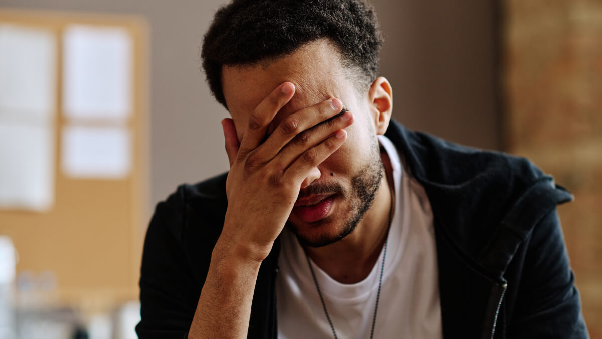 Man with hand on face