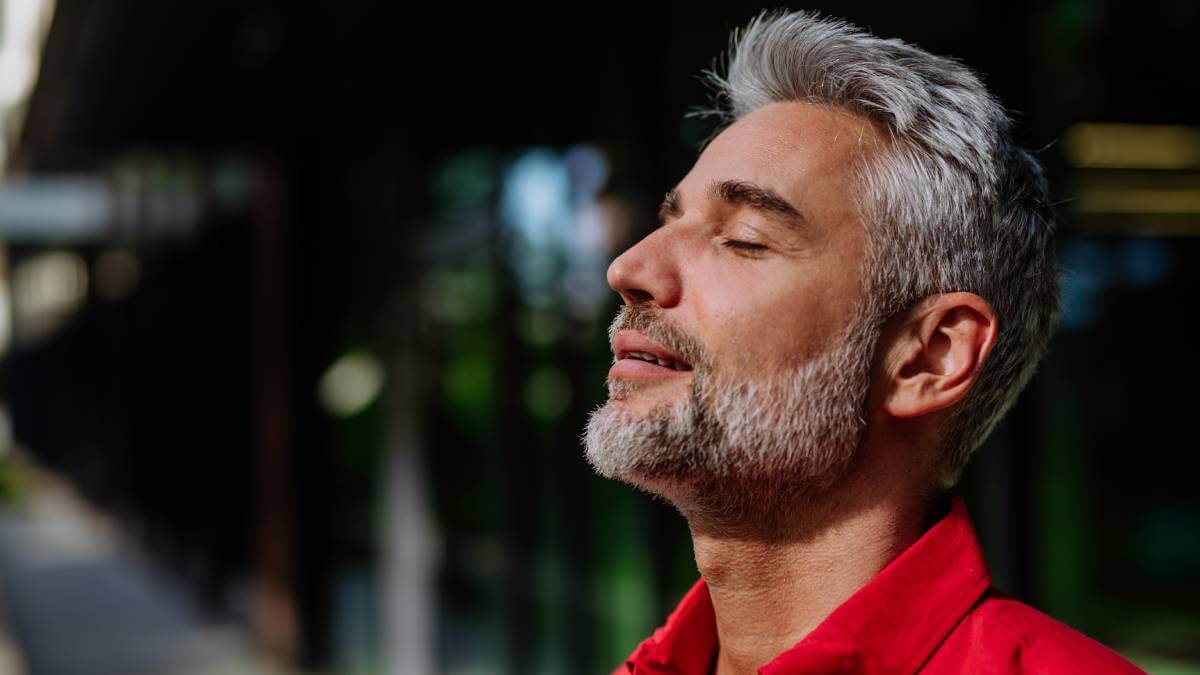 Man with eyes shut looking relieved